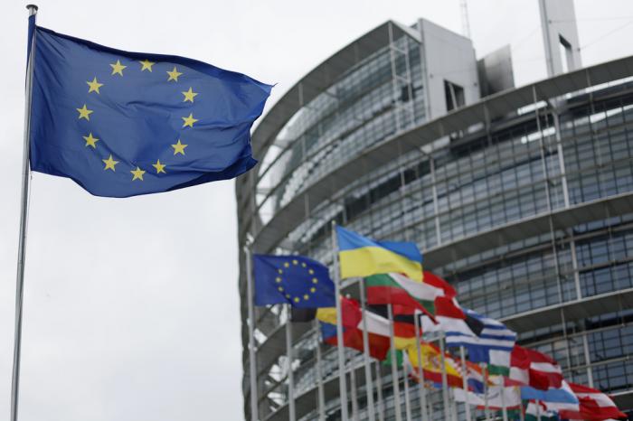 The European flag, left, flies Tuesday, April 18, 2023 at the European Parliament in Strasbourg, eastern France. 