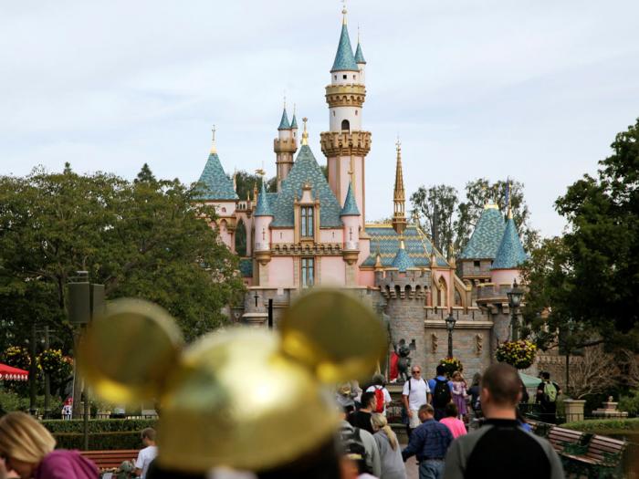 Visitors walk toward Sleeping Beauty's Castle in the background at Disneyland Resort on Jan. 22, 2015, in Anaheim, Calif.