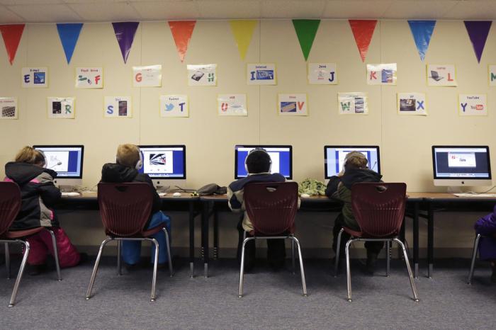 Watford City Elementary School students use computers in a portable building in Watford City, N.D., Dec. 17, 2014.