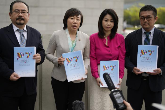 Yuri Igarashi, second left, a senior member of the Japan Alliance for LGBT Legislation, and other LGBTQ activist groups' leaders, speaks to the media, holding copies of their first Pride 7 communique, in Tokyo, Japan, Friday, April 21, 2023. 