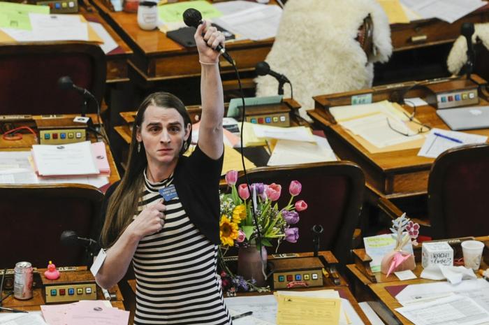 Montana state Rep. Zooey Zephyr, D-Missoula, alone on the House floor stands in protest as demonstrators are arrested in the House gallery, Monday, April 24, 2023, at the state Capitol in Helena, Mont.