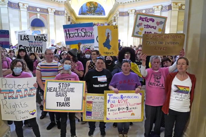 Trans-rights activists protest outside the House chamber at the Oklahoma Capitol before the State of the State address, Feb. 6, 2023, in Oklahoma City.