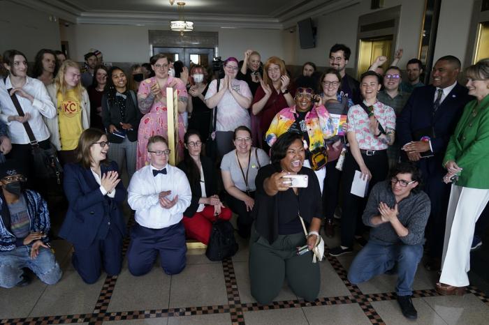 Supporters of a resolution that would make Kansas City, Mo, a sanctuary city for transgender people celebrate outside of city council chambers after a committee approved the resolution, sending it to the full council for consideration, Wednesday, May 10, 2023, in Kansas City, Mo.