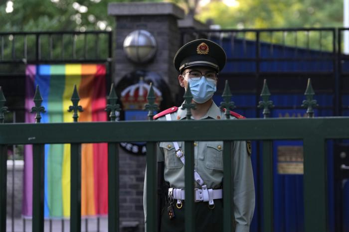 A Chinese paramilitary policemen stands guard outside the Swedish embassy during the opening ceremony for Diversity Week in Beijing, Friday, May 12, 2023.