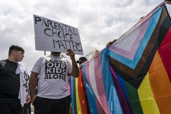 People protesting a planned Pride month assembly and counterprotesters with Pride flags stand outside Saticoy Elementary School in Los Angeles, Friday, June 2, 2023.