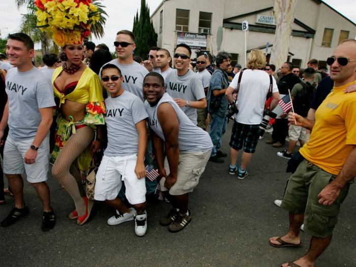 Navy personel pose for a picture with drag queen Bianca Sullivan before marching in the San Diego gay pride parade July 16, 2011 in San Diego, California.