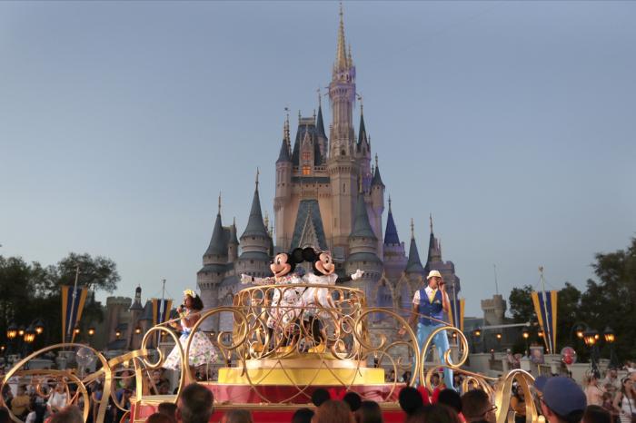 Mickey and Minnie Mouse perform during a parade as they pass by the Cinderella Castle at the Magic Kingdom theme park at Walt Disney World in Lake Buena Vista, Fla., on Jan. 15, 2020. 