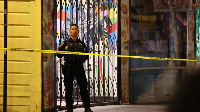 Police secure and investigate the scene of a shooting in San Francisco on Friday, June 9, 2023. Multiple victims were struck by bullets during a mass shooting in the Mission District Friday night, but authorities said there were no fatalities. (Santiago Mejia /San Francisco Chronicle via AP)