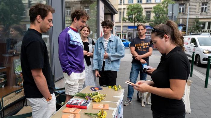 University student activists give out free books in protest against a contentious Hungarian law on homosexuality in media, on Wednesday, July 26, 2023 in Budapest, Hungary. 