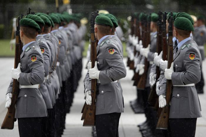 Soldiers of the honor guard prepare for a military welcome ceremony as part of a meeting of German Defence Minister Ursula von der Leyen and her counterpart from Great Britain Michael Fallon, in Berlin, Germany, Tuesday, Aug. 12, 2014.