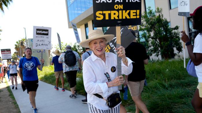 Actor Holland Taylor walks on a picket line outside Netflix studios on Wednesday, July 26, 2023, in Los Angeles. The actors strike comes more than two months after screenwriters began striking in their bid to get better pay and working conditions. (AP Photo/Chris Pizzello)
