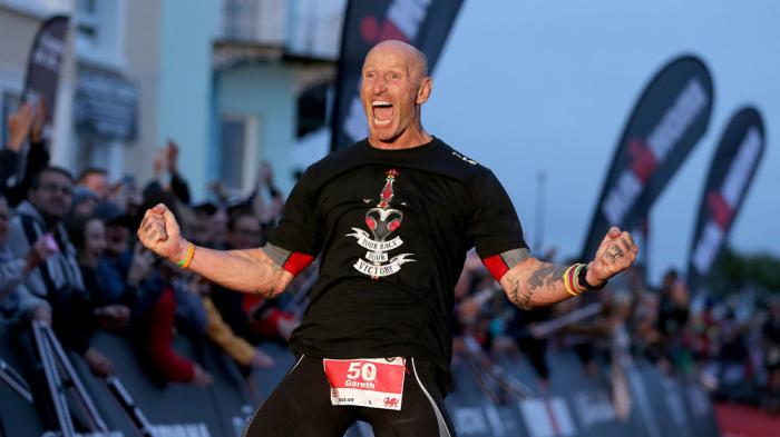 Former Welsh rugby International captain Gareth Thomas reacts after finishing Ironman Wales on September 15, 2019 in Tenby, Wales. (Photo by Nigel Roddis/Getty Images for IRONMAN)