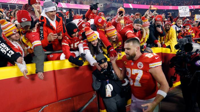  Kansas City Chiefs tight end Travis Kelce (87) celebrates with fans as he walks off the field after an NFL divisional round playoff football game against the Buffalo Bills, Sunday, Jan. 23, 2022, in Kansas City, Mo. 