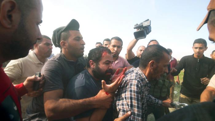 Palestinians transport a captured Israeli civilian, center, from Kibbutz Kfar Azza into the Gaza Strip on Saturday, Oct. 7, 2023. The militant Hamas rulers of the Gaza Strip carried out an unprecedented, multi-front attack on Israel at daybreak Saturday, firing thousands of rockets as dozens of Hamas fighters infiltrated the heavily fortified border in several locations by air, land, and sea and catching the country off-guard on a major holiday. (AP Photo/Hatem Ali, File)