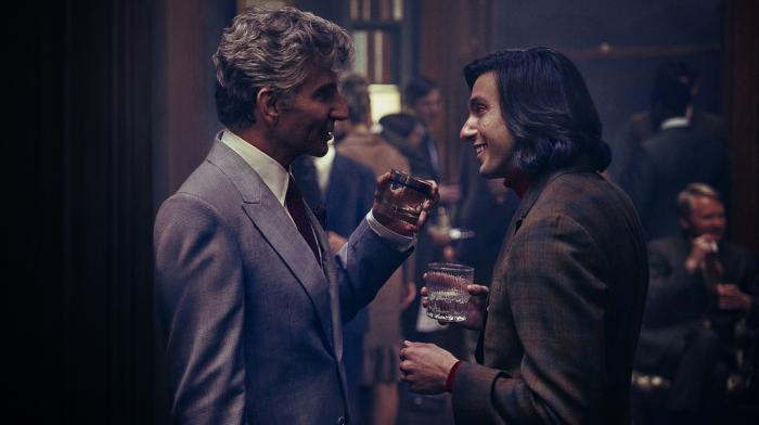Bradley Cooper as Leonard Bernstein, left, and Gideon Glick as Tommy Cothran in a scene from "Maestro."
