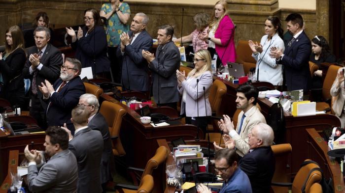 Members of the Utah House of Representatives applaud for the athlete who was the subject of school board member Natalie Cline's comments on social media after passing the House Concurrent Resolution Condemning and Censuring State School Board Member Natalie Cline at the Capitol in Salt Lake City on Thursday, Feb. 15, 2024. 