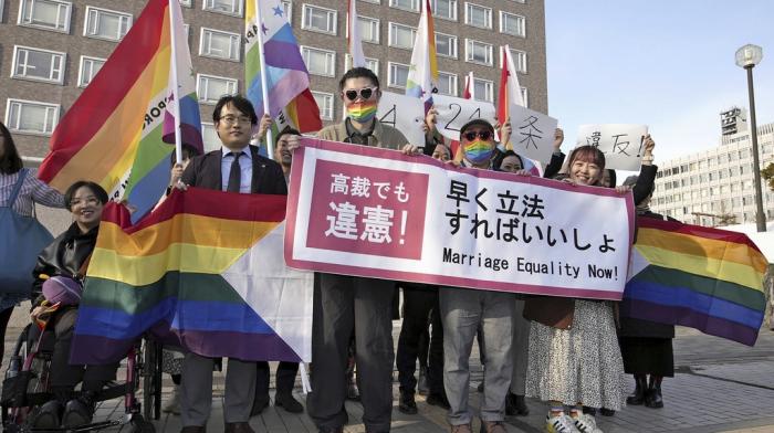 Plaintiffs and others shows a banner in front of Sapporo Hight Court in Sapporo, Hokkaido, northern Japan Thursday, March 14, 2024.