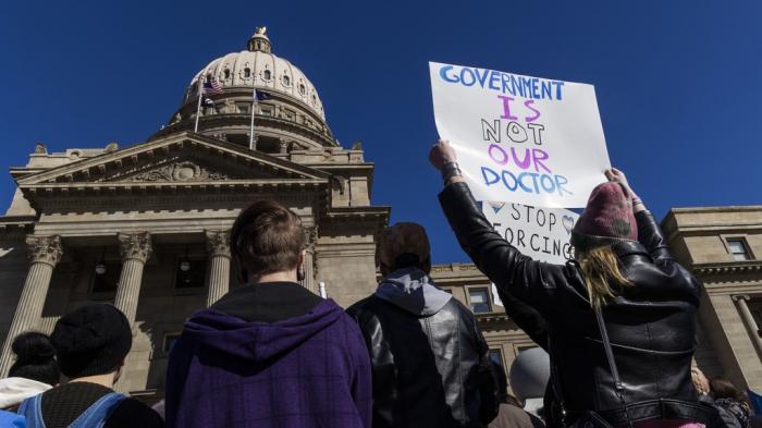 People gather in front of the Idaho Statehouse in opposition to anti-transgender legislation moving through an Idaho Republican congress, Friday, Feb. 24, 2023, in Boise, Idaho. 