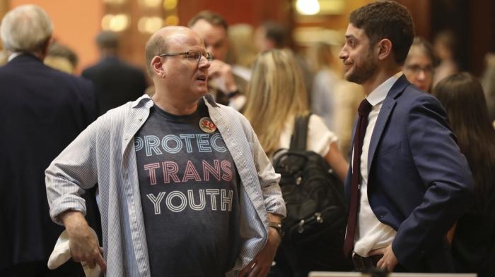 Brent Cox, left, talks to Josh Malkin, right, of the South Carolina chapter of the American Civil Liberties Union, right, as they wait to talk to lawmakers in the lobby of the Statehouse on Wednesday, May 1, 2024, in Columbia, S.C. 