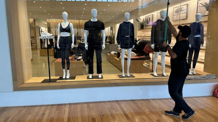 A cleaner works on the display window of a clothing store in a mall on April 29, 2024, in Lone Tree, Colo. On Friday, May 31, 2024, the Commerce Department issues its report on consumer spending for April. (AP Photo/David Zalubowski, File)