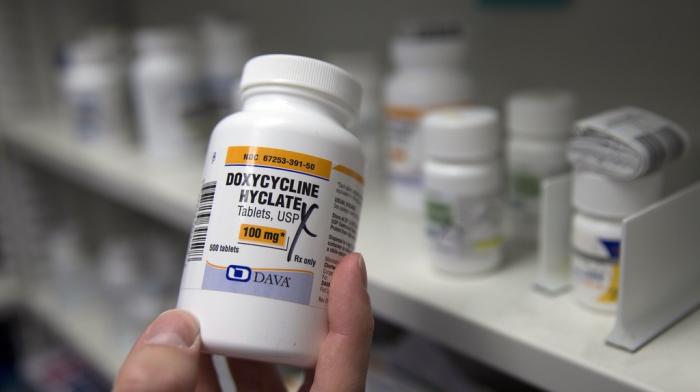 A pharmacist holds a bottle of the antibiotic doxycycline hyclate in Sacramento, Calif., July 8, 2016.