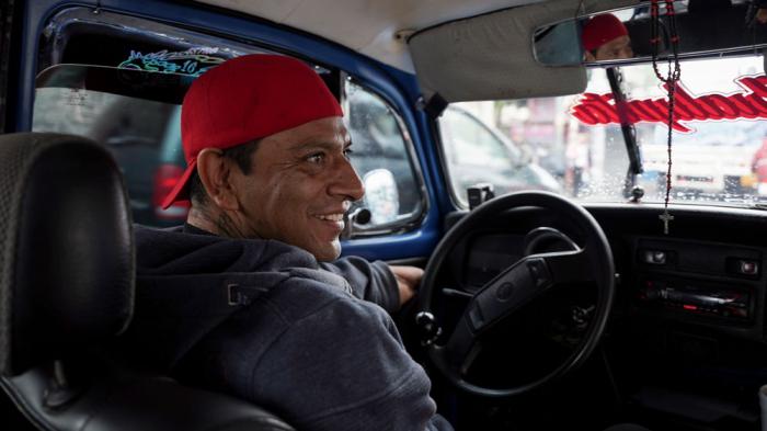 Taxi driver Claudio Garcia sits inside his Volkswagen Beetle he has named "Gualupita" after his wife, in the Cuautepec neighborhood of Mexico City, Friday, June 21, 2024. While some of the older Beetles wobble along, paint long faded after years of wear and tear, other drivers like Garcia dress their cars up, keeping them in top shape. (AP Photo/Aurea Del Rosario)<br><br>