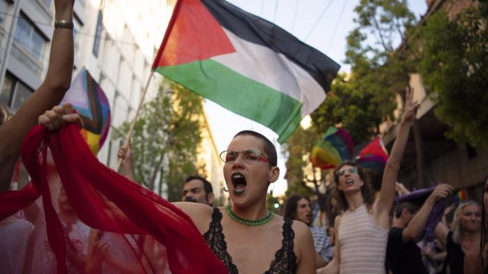 Protesters shout slogans against Israel's military operation in Gaza Strip during the annual Pride parade, in Athens, Greece, June 15, 2024.