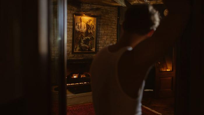 Model Model Mickey DiPietro stands in the lobby of Crew's Quarters Boarding House.