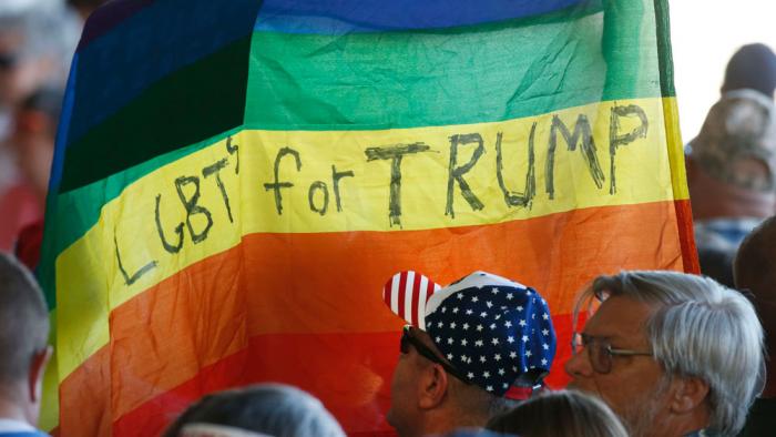 Supporters hold up a gay pride flag for Republican presidential candidate Donald Trump on October 18, 2016 in Grand Junction Colorado. Trump is on his way to Las Vegas for the third and final presidential debate against Democratic rival Hillary Clinton. (Photo by George Frey/Getty Images