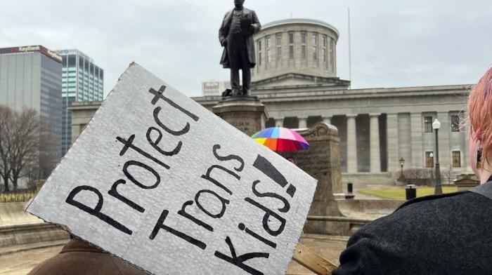 Demonstrators advocating for transgender rights and healthcare stand outside of the Ohio Statehouse, Jan. 24, 2024, in Columbus, Ohio.