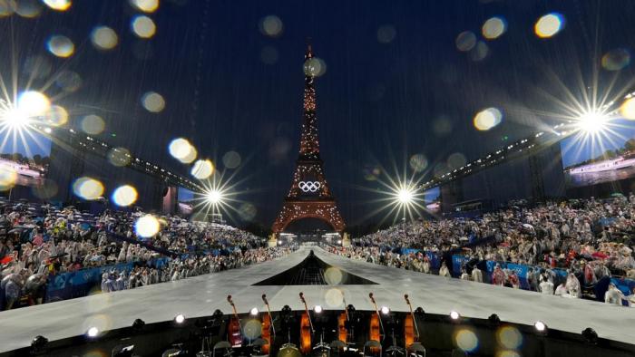 Rain pours down in Paris, France, during the opening ceremony of the 2024 Summer Olympics, Friday, July 26, 2024. (AP Photo/Chris Carlson)