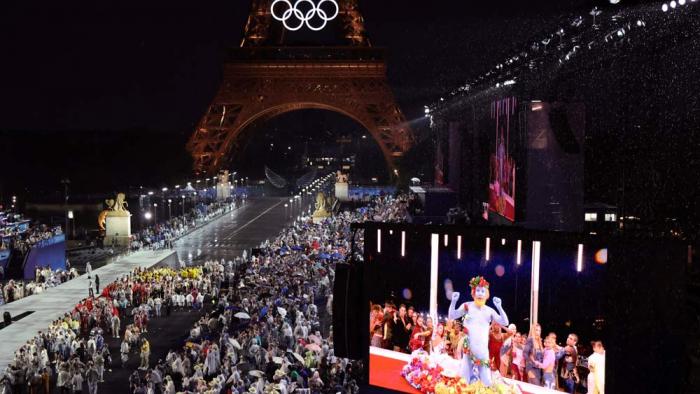 Delegations arrive at the Trocadero as spectators watch French singer Philippe Katerine performing on a giant screen, in Paris, during the opening ceremony of the 2024 Summer Olympics, Friday, July 26, 2024 in Paris. (Ludovic Marin/Pool Photo via AP)