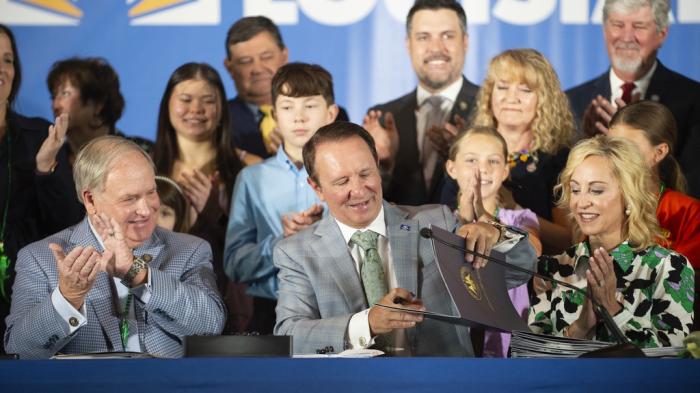 Louisiana Gov. Jeff Landry signs bills June 19, 2024, at Our Lady of Fatima Catholic School in Lafayette, La.