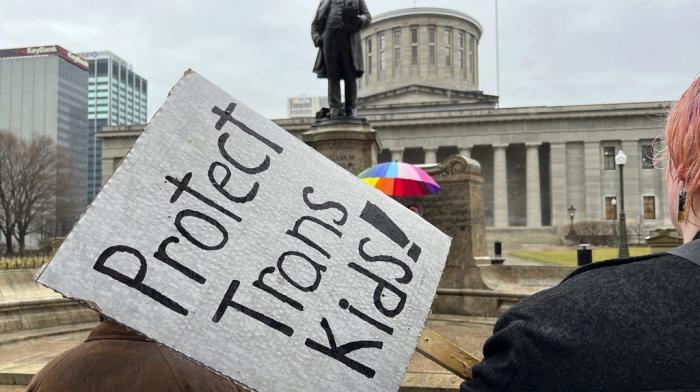 Demonstrators advocating for transgender rights and healthcare stand outside of the Ohio Statehouse, Jan. 24, 2024, in Columbus, Ohio.