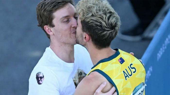 Aussie Olympian Campbell Harrison kisses his boyfriend Justin at the Paris Olympics.