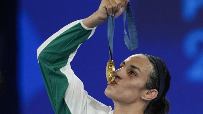 Gold medalist Algeria's Imane Khelif kisses her medal for the women's 66 kg final boxing match at the 2024 Summer Olympics, Friday, Aug. 9, 2024, in Paris, France. 