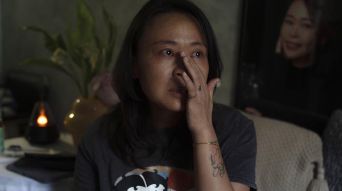 Zhang Peiyi, a Shanghai resident, tears up during an interview at her home in Shanghai on July 31, 2024.