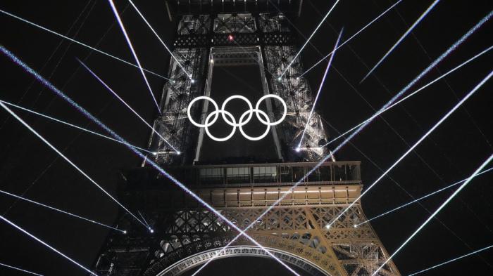 A light show is projected from the Eiffel Tower in Paris, France, during the opening ceremony of the 2024 Summer Olympics, July 26, 2024. 