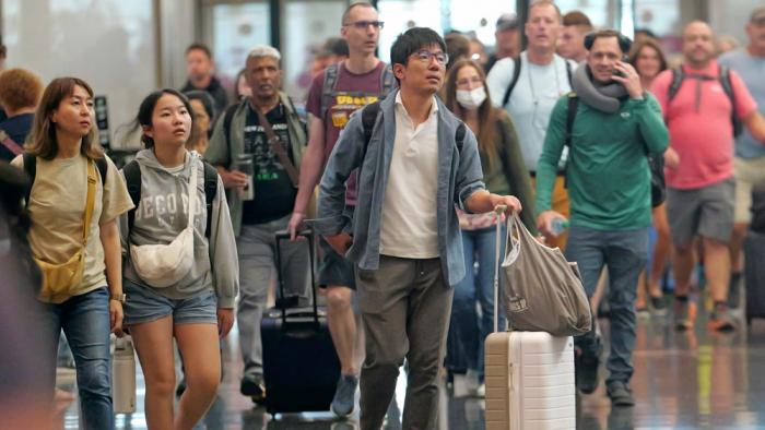 Travelers pass through Salt Lake City International Airport on July 3, 2024, in Salt Lake City