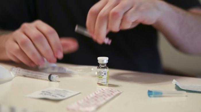 Lucas prepares his weekly testosterone shot at his home in Casselberry, Fla., May 29, 2023. The Associated Press is not using Lucas' last names because he fears reprisal.