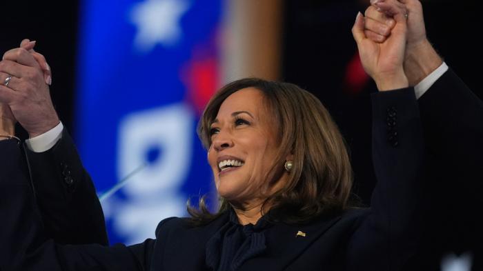 Democratic presidential nominee Vice President Kamala Harris celebrates with her families as the balloons fall during the final day of during the Democratic National Convention Thursday, Aug. 22, 2024, in Chicago