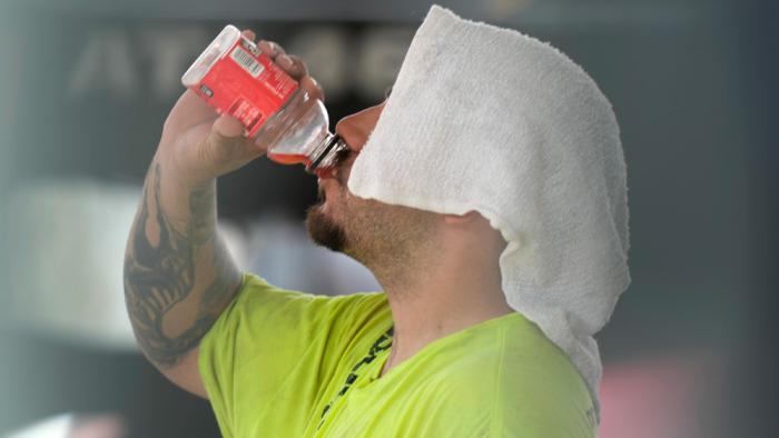 A construction worker hydrates at the Shedd Aquarium Tuesday, Aug. 27, 2024, as a second straight day of hot soupy temperatures approaching triple digits hung over much of the Midwest in Chicago