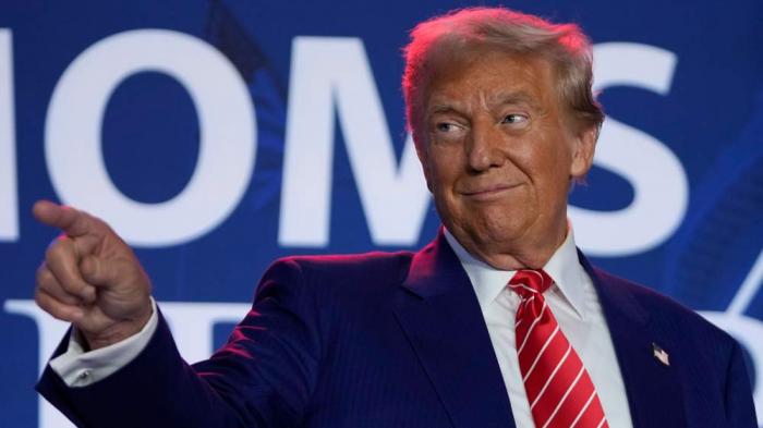 Republican presidential nominee former President Donald Trump arrives to speak with Moms for Liberty co-founder Tiffany Justice during an event at the group's annual convention in Washington, Friday, Aug. 30, 2024. (AP Photo/Mark Schiefelbein)