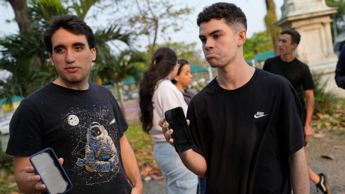 University students show their phone screens after social media platform X was blocked nationwide, in Rio de Janeiro, Monday, Sept. 2, 2024