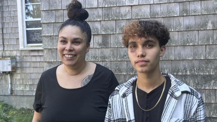 Jayden Tkaczyk stands outside his house with his mother, Jasmine Tkaczyk.