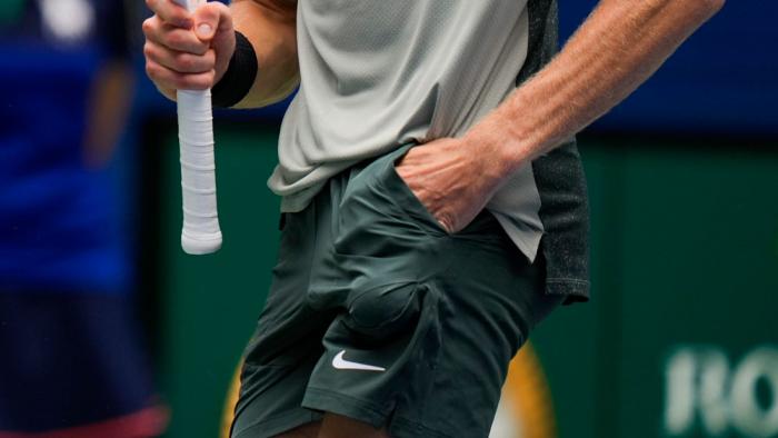 Jannik Sinner, of Italy, reaches for a ball in his pocket before serving to Alex Michelsen, of the United States, during the second round of the U.S. Open tennis championships, Aug. 29, 2024, in New York