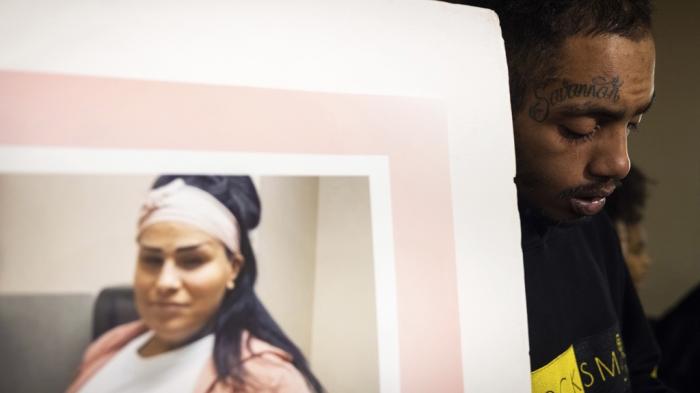 Courtuni Mason stands next to a poster of his partner Savannah Williams during a press conference at the State Capitol on Dec. 7, 2023, in St. Paul, Minn.