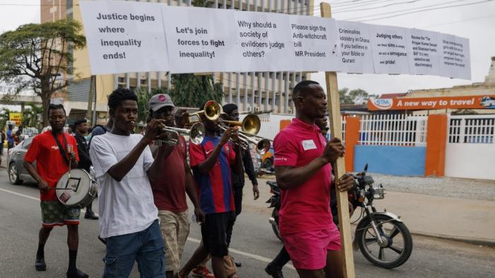 Texas Kadri Moro, the Executive Director of Arise for Justice International, protests with placards nailed on a cross on the street of Accra, Ghana, Thursday Sept 12, 2024.