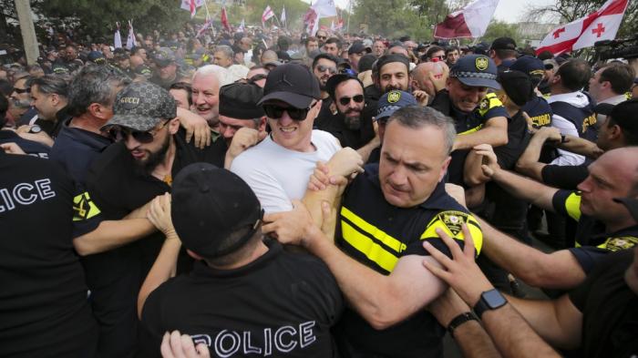 Police block Georgian opponents of gay rights as they try to interfere a pride party in Tbilisi, Georgia, Saturday, July 8, 2023.