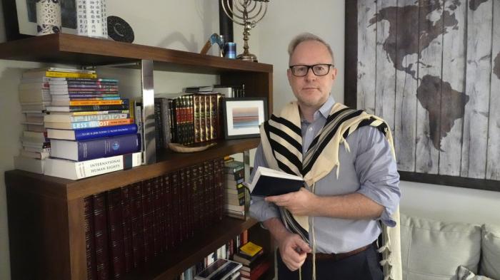 Daniel Gammerman poses for a photo in his home where he plans to worship privately during the Jewish High Holy Days, Thursday, Sept. 26, 2024, in Miami.